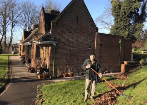 Gardener working at Glover's clearing leaves