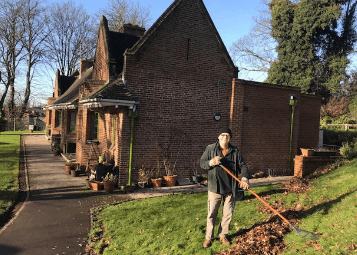 Gardener working at Glover's clearing leaves